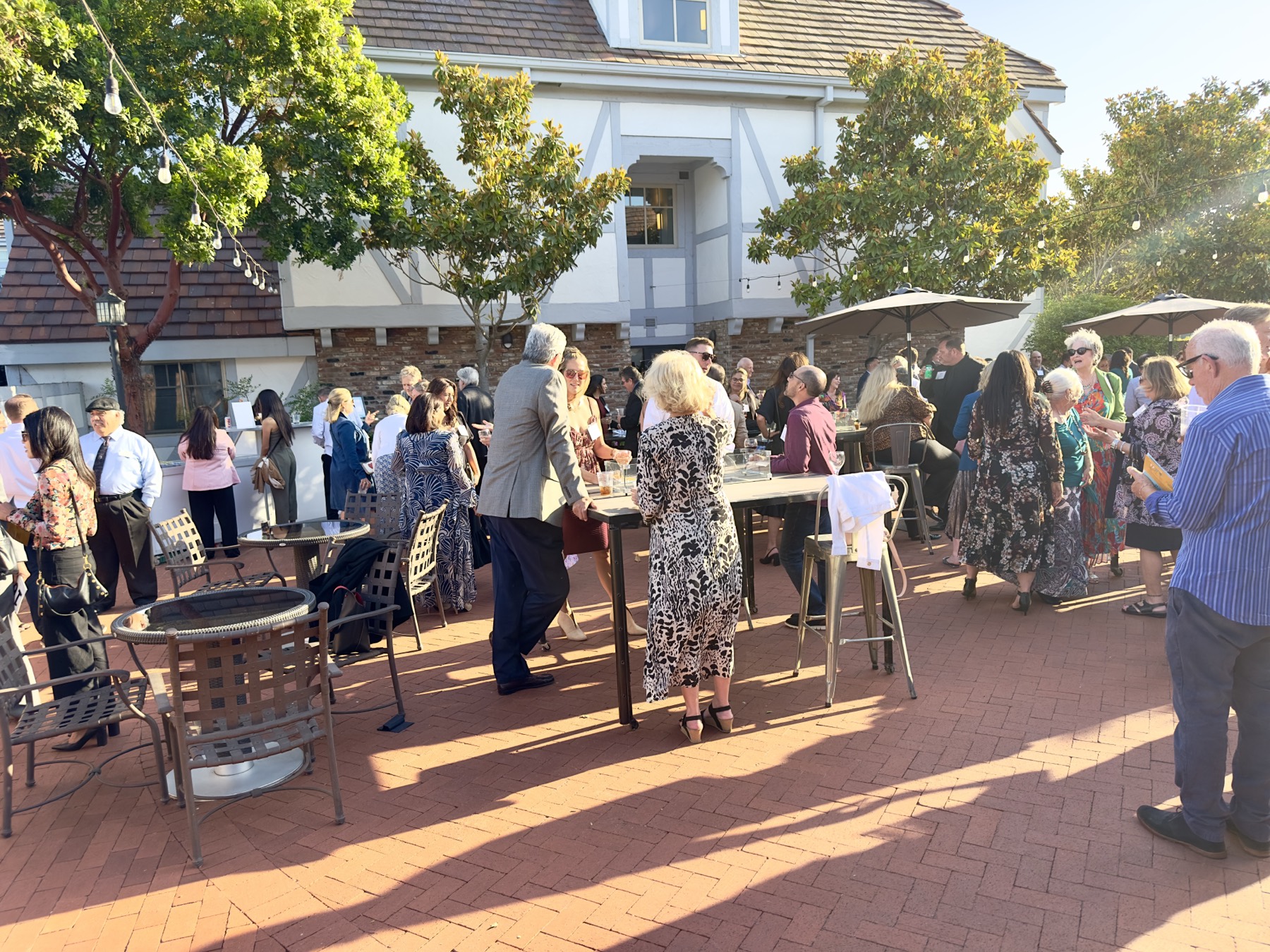 Guests mingling on the patio during the golden-hour reception