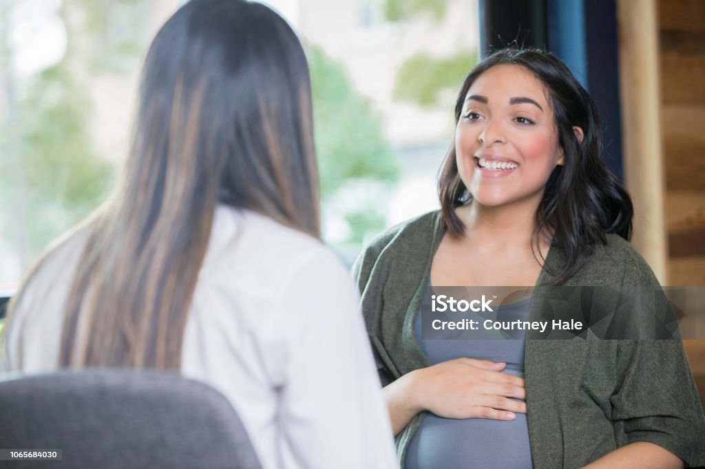A pregnant woman meeting with a CommUnify staff member